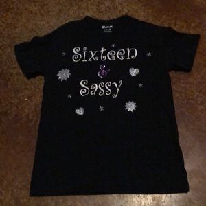 A black shirt from Gildan that says sixteen and sassy